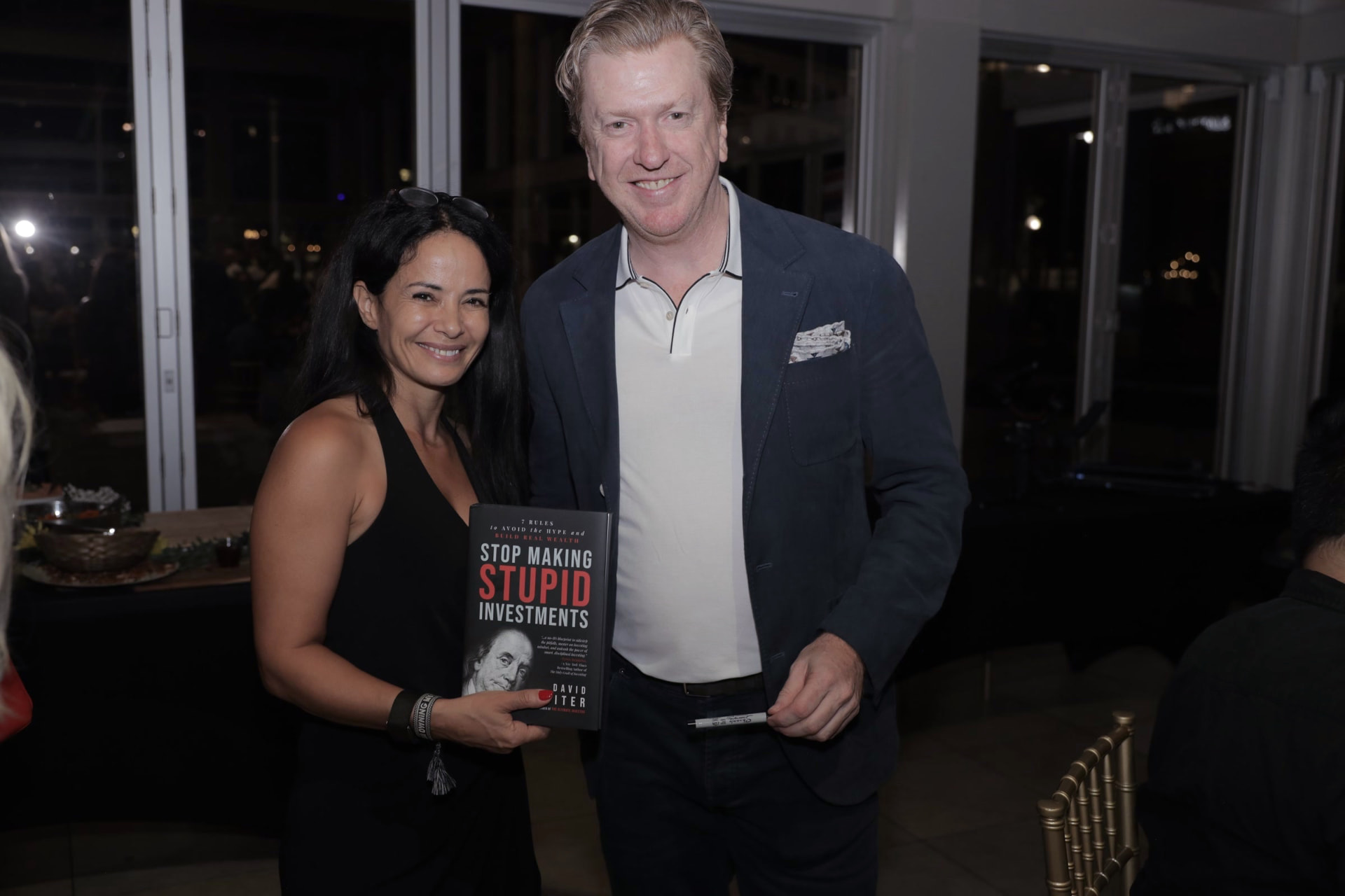An author signing and presenting his book with a guest